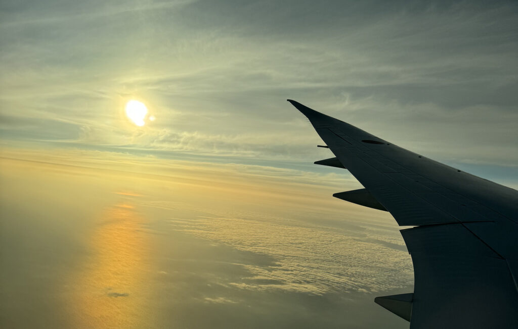 飛行機の翼と朝日が広がる空の風景｜退院という節目と生活期の新しいステージの始まりを象徴する写真